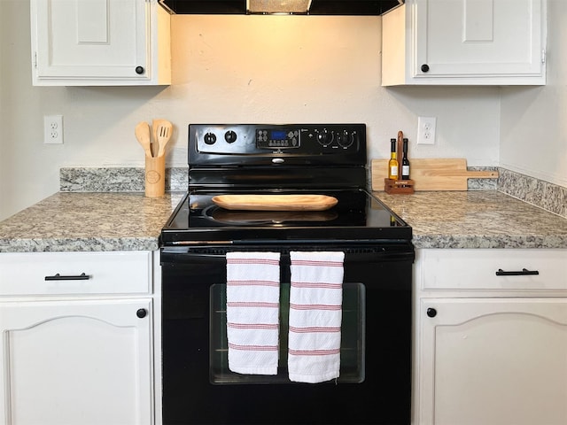 kitchen with white cabinetry, range hood, and black / electric stove