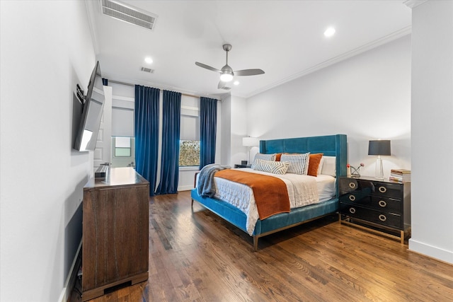 bedroom with dark wood-type flooring, ornamental molding, and ceiling fan