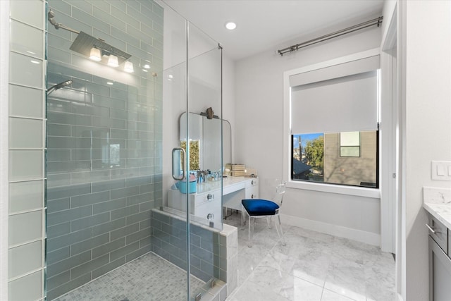 bathroom featuring walk in shower and vanity