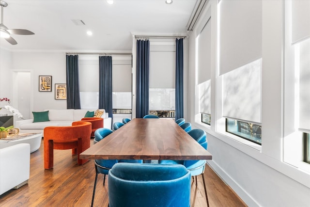 dining space with ceiling fan, ornamental molding, and hardwood / wood-style floors