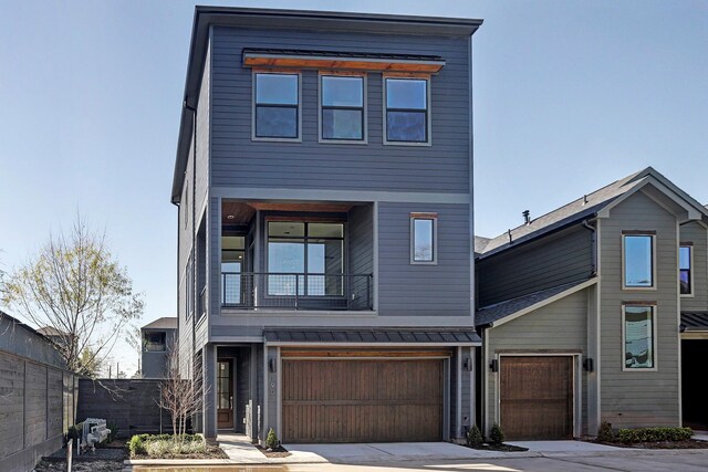 modern home with a balcony and a garage