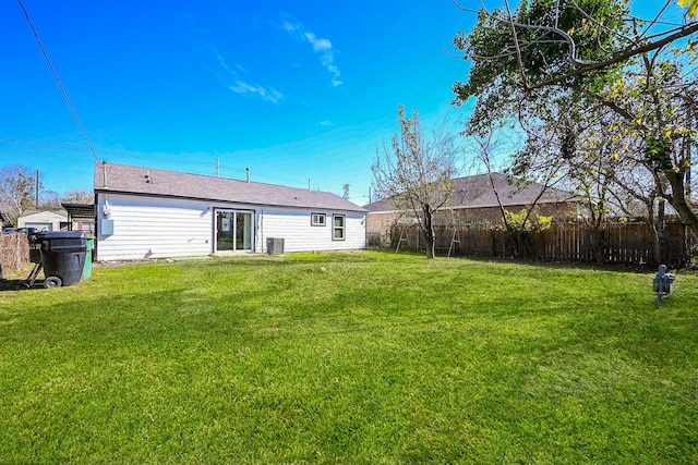 rear view of property with a yard