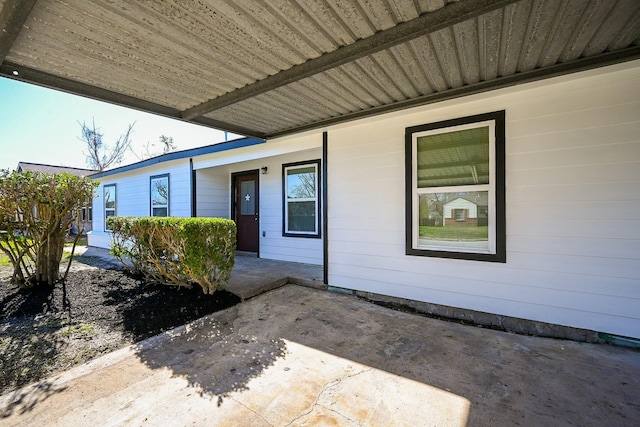 view of exterior entry featuring a patio area