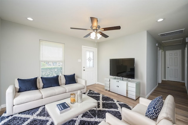 living room featuring hardwood / wood-style flooring and ceiling fan