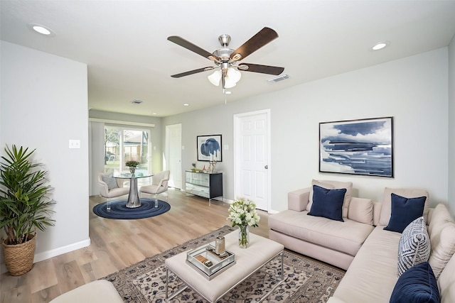 living room featuring hardwood / wood-style floors and ceiling fan