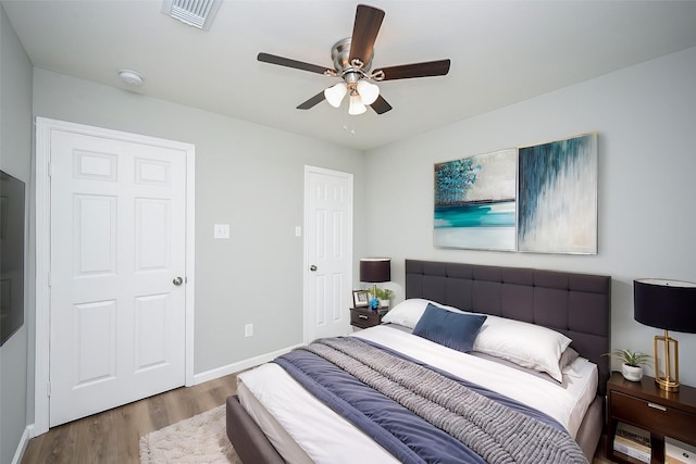 bedroom with hardwood / wood-style flooring and ceiling fan