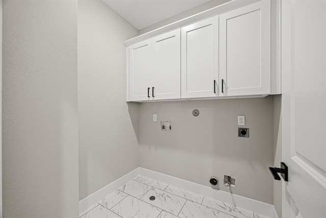 clothes washing area featuring cabinets, hookup for a gas dryer, hookup for a washing machine, and hookup for an electric dryer