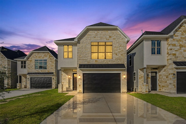 view of front of property with a garage and a lawn