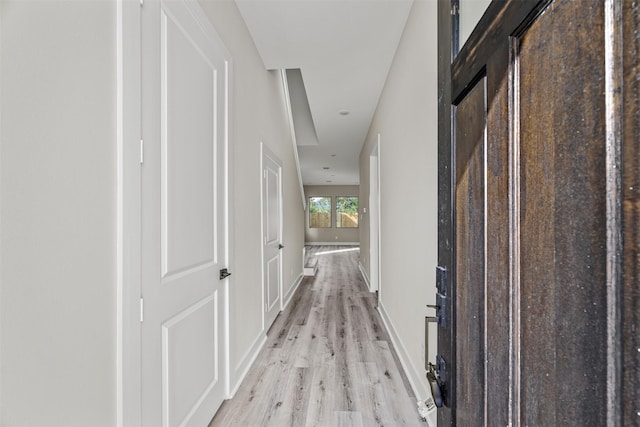 corridor with light hardwood / wood-style flooring