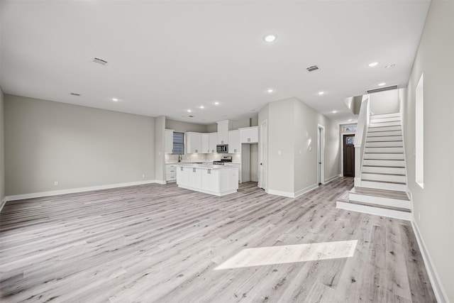 unfurnished living room with light hardwood / wood-style flooring