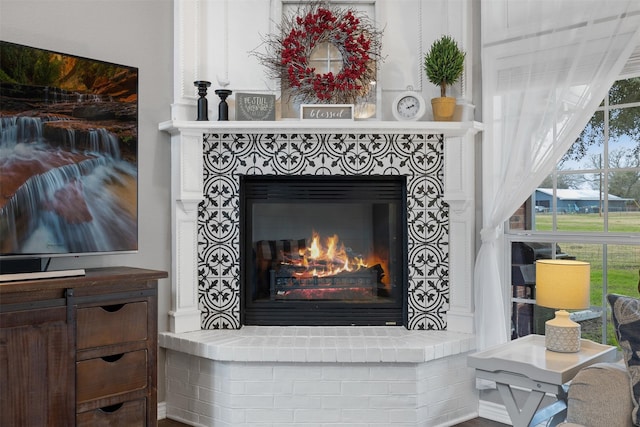 interior details featuring a tiled fireplace