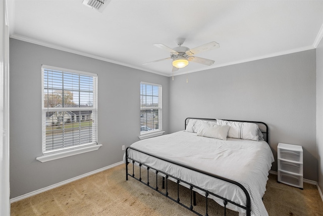 carpeted bedroom with ceiling fan and ornamental molding