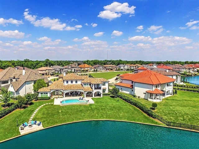 view of swimming pool with a water view and a lawn