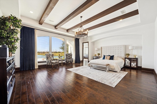 bedroom with a notable chandelier, beam ceiling, dark wood-type flooring, and a water view