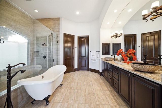 bathroom with vanity and shower with separate bathtub