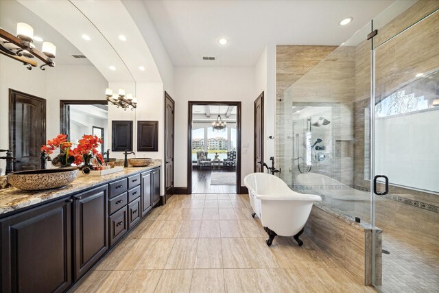 bathroom with vanity, a notable chandelier, and shower with separate bathtub