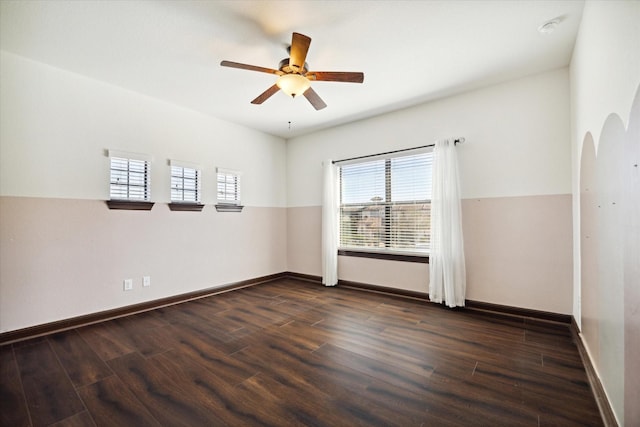 unfurnished room featuring dark wood-type flooring and ceiling fan