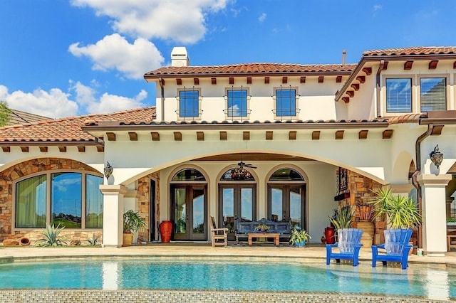 rear view of property with a patio, a balcony, an outdoor hangout area, ceiling fan, and french doors