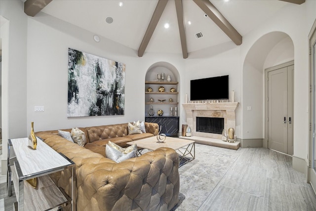 living room featuring a premium fireplace, high vaulted ceiling, built in features, and beam ceiling