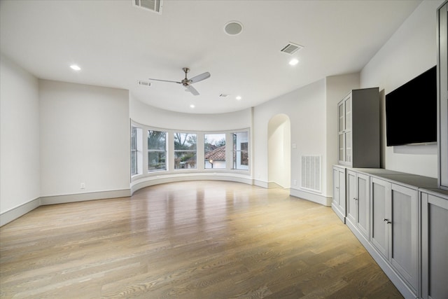 unfurnished living room with light hardwood / wood-style flooring and ceiling fan