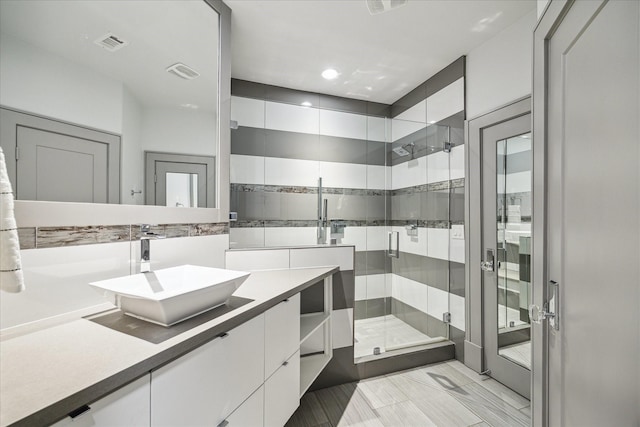 bathroom with vanity and an enclosed shower