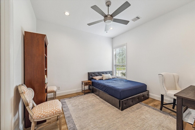 bedroom with ceiling fan and hardwood / wood-style floors