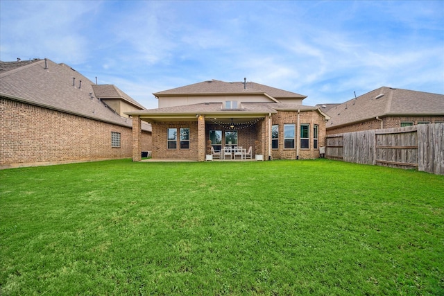 back of property featuring a patio and a lawn