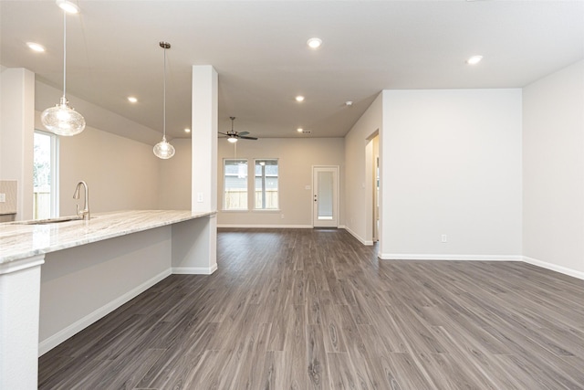 unfurnished living room featuring recessed lighting, ceiling fan, baseboards, and wood finished floors