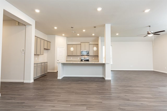 kitchen with range, decorative backsplash, dark wood-style floors, stainless steel microwave, and open floor plan