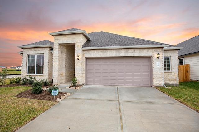 view of front facade with a yard and a garage