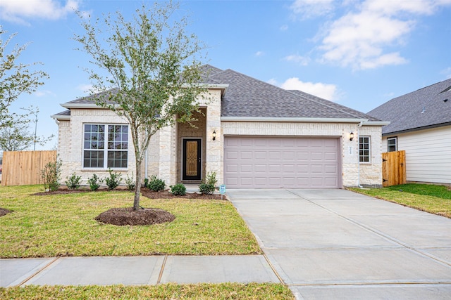 ranch-style home with a garage and a front yard