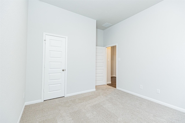 unfurnished bedroom with carpet flooring, visible vents, and baseboards