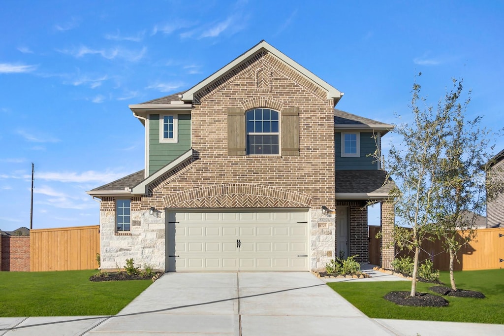 view of front of house with a garage and a front lawn