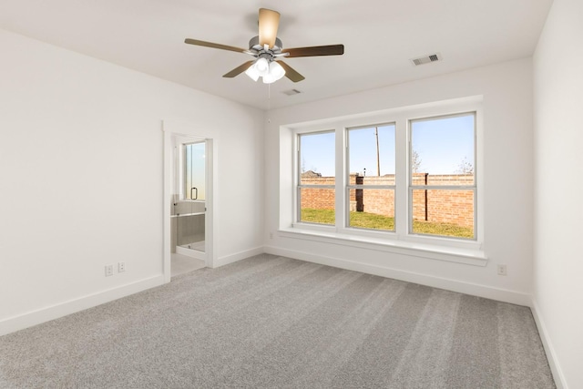 spare room featuring carpet floors and ceiling fan