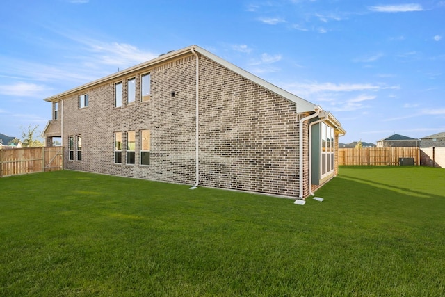 rear view of house featuring a yard