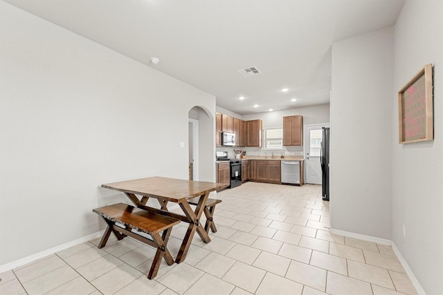 dining space with light tile patterned floors