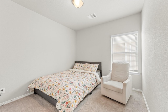 carpeted bedroom featuring multiple windows