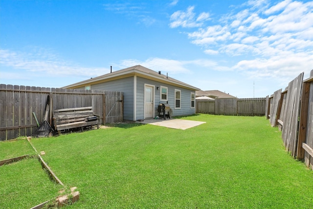 back of property with a yard and a patio area