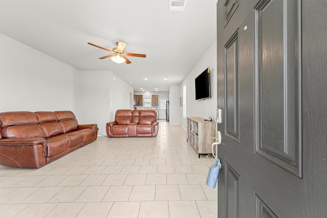 tiled living room with ceiling fan