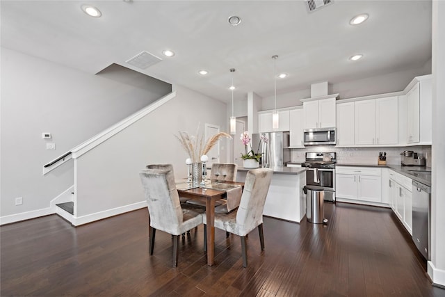 dining space with dark hardwood / wood-style floors