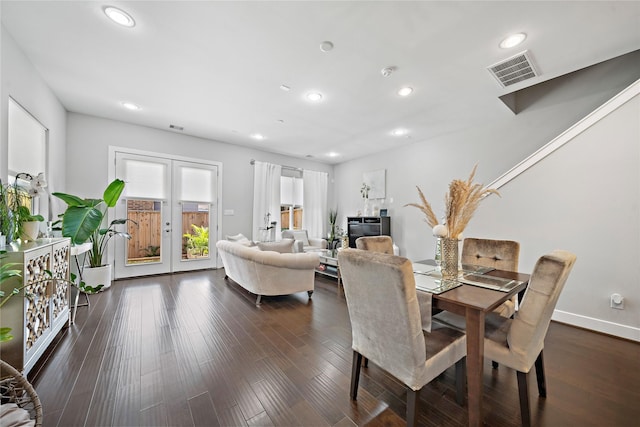 dining space with dark hardwood / wood-style floors and french doors