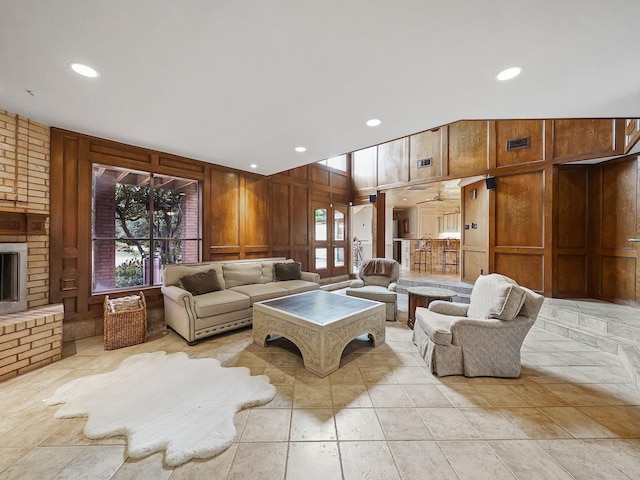 tiled living room with a fireplace and wooden walls