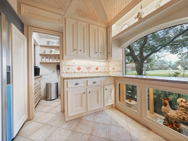 kitchen with light tile patterned flooring, wooden ceiling, and backsplash