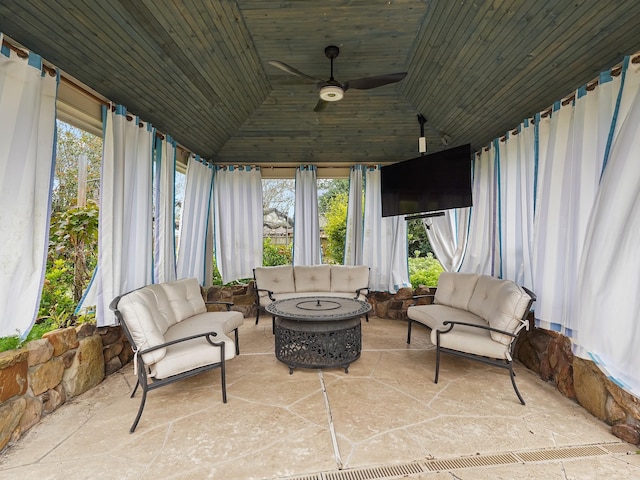 sunroom featuring lofted ceiling, wood ceiling, a wealth of natural light, and ceiling fan