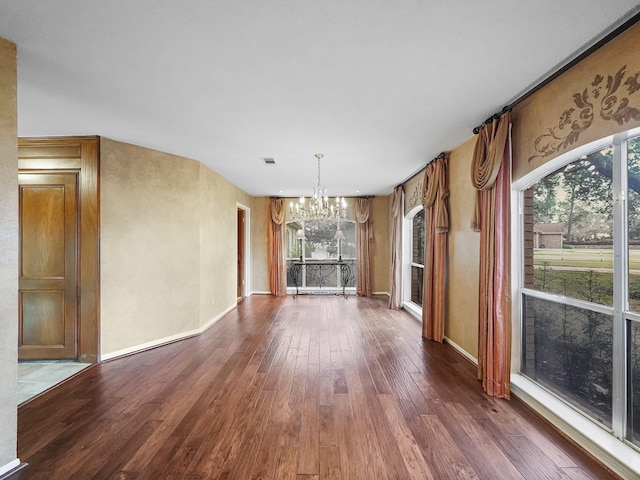 unfurnished dining area featuring hardwood / wood-style floors and a notable chandelier