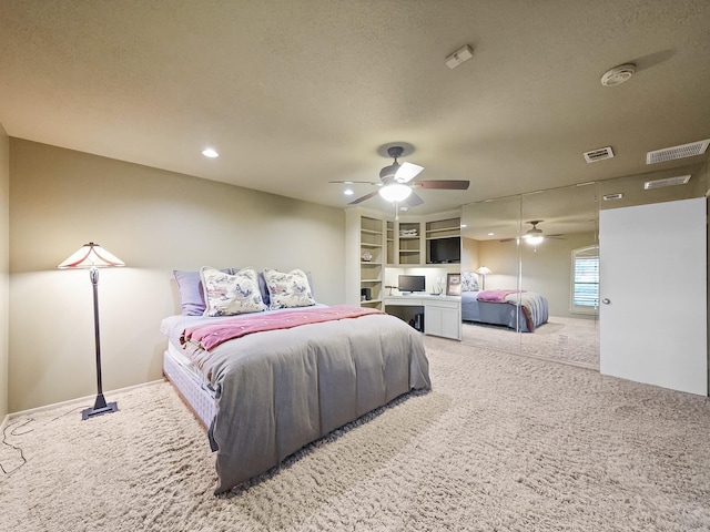 bedroom featuring light colored carpet and a textured ceiling