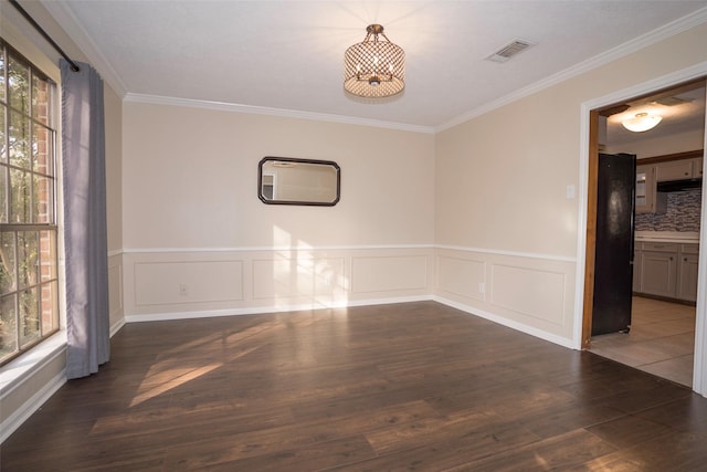 unfurnished dining area with crown molding, plenty of natural light, and dark wood-type flooring