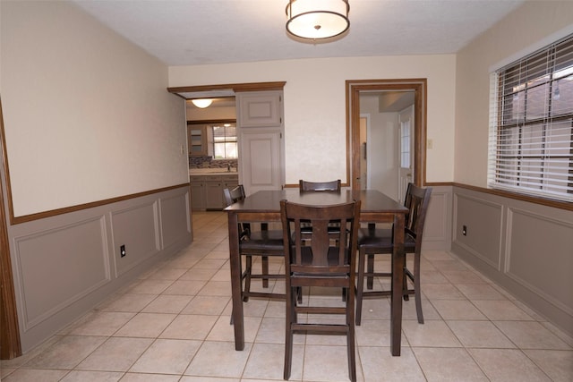 dining room featuring light tile patterned floors and sink