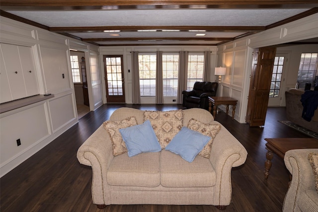 living room with dark hardwood / wood-style flooring, beam ceiling, and a textured ceiling