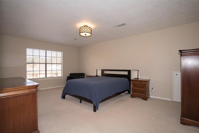 carpeted bedroom featuring a textured ceiling